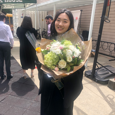 Award winner Maggie Chen holding a bouquet of flowers.