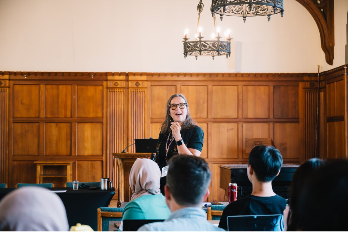 Vice-Principal Pam McCarroll stands at the front of the room, speaking to a group of incoming Emmanuel College students.