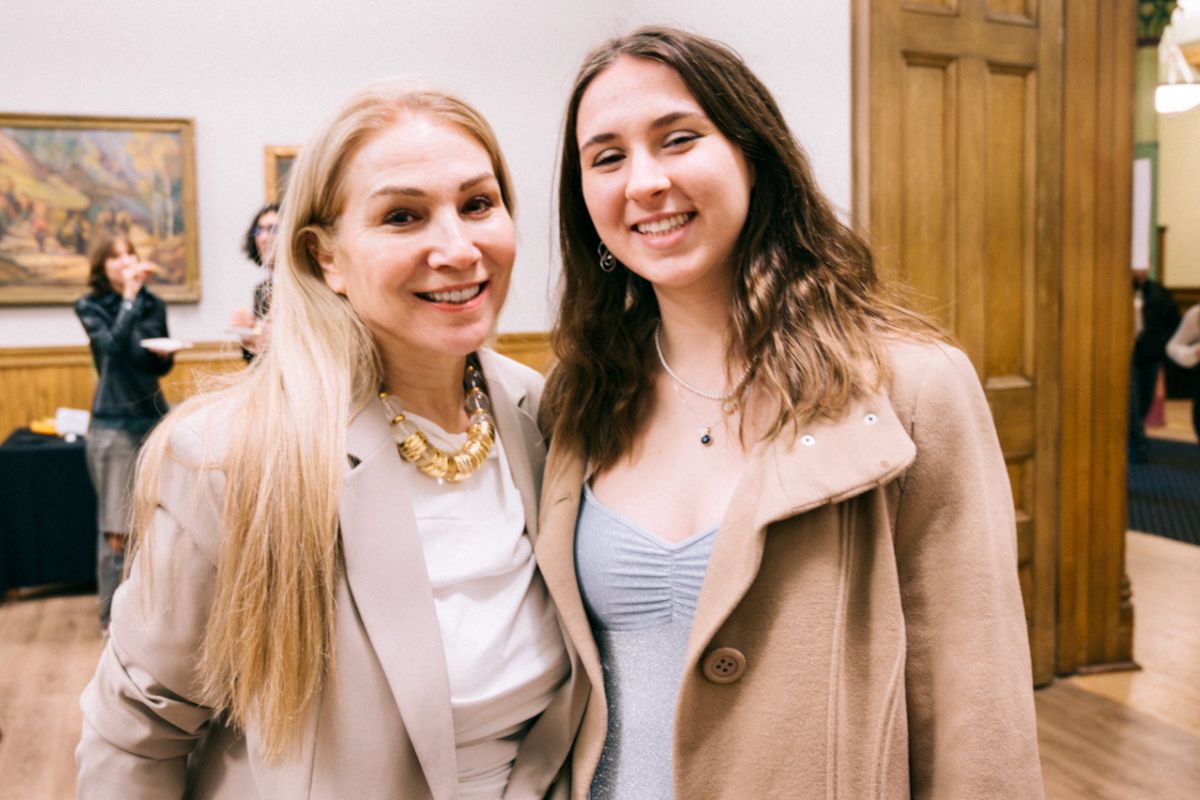 Liliana Malat stands with her mother, enjoying the graduate reception at Victoria Coollege.