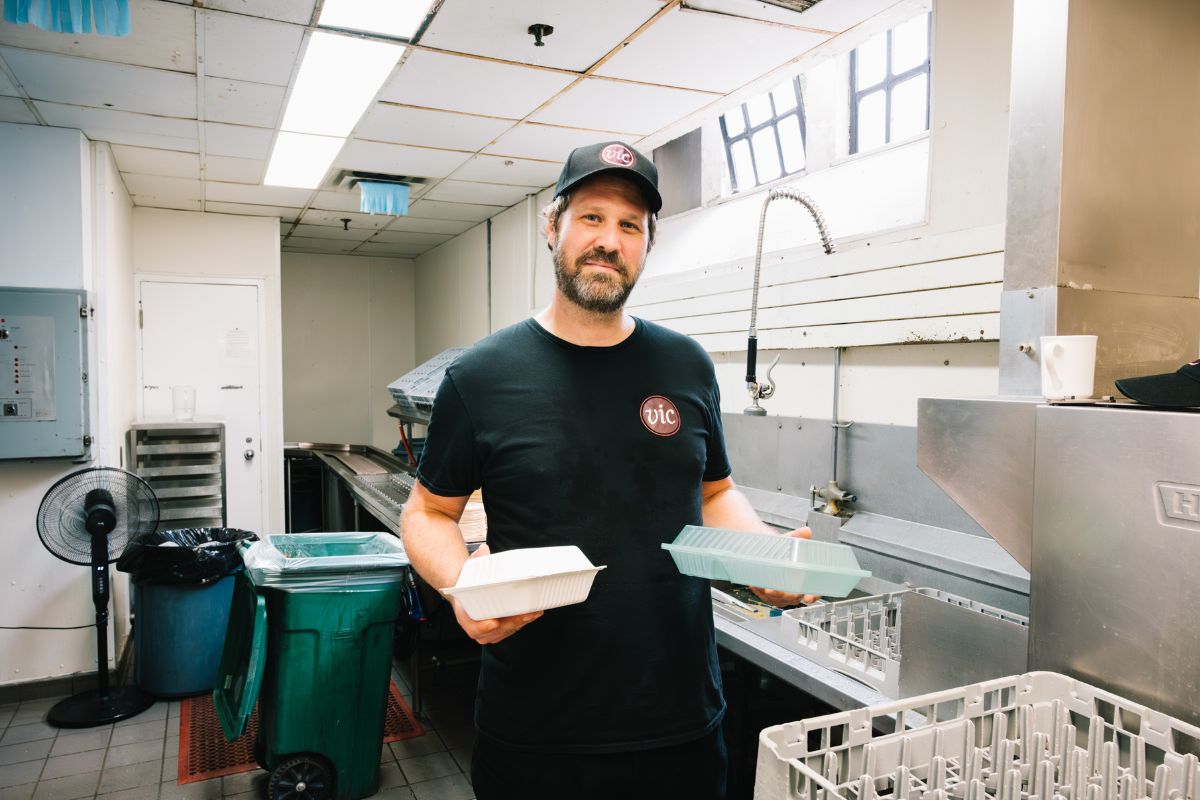 Evan May, a member of the food services team at Victoria University, poses in the kitchen of Burwash Dining Hall. 