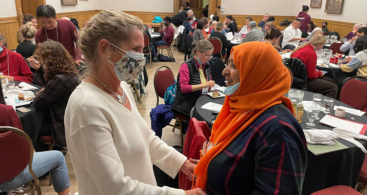 Ontario Premier Kathleen Wynne warmly embraces an attendee during a Humanities for Humanity event at Victoria University, University of Toronto.